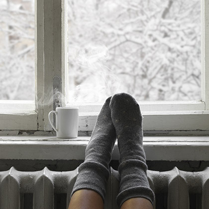 Feet up on window sill with coffee